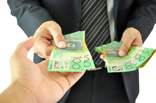 Hand receiving money - Australian dollar -  from a businessman