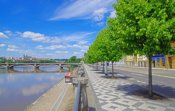 Street and view of Prague Castle and river in Czech Republic