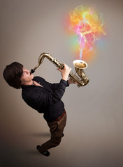 Attractive musician playing on saxophone with colorful abstract