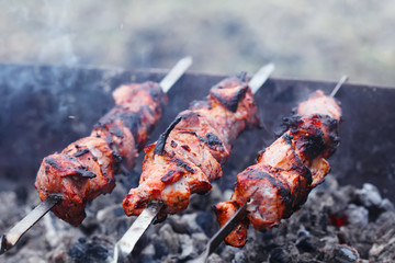 slices of meat prepare on fire with smoke