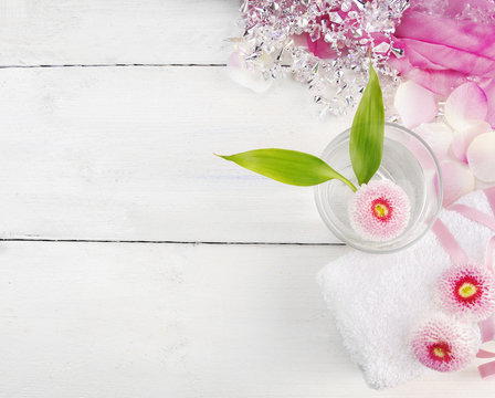 pink spa set, daisies flowers, glass of water , rolled up towel Stock Photo  | Adobe Stock