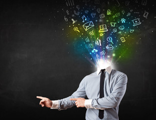 Business man with glowing media icons exploding head