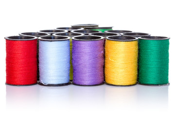 Colorful bobbins on white