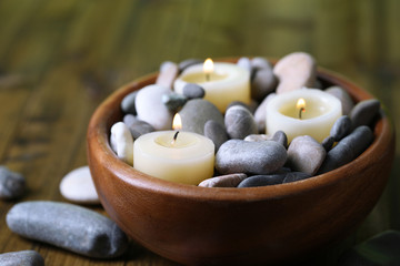 Fototapeta na wymiar Composition with spa stones, candles on wooden background