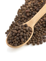 pepper in spoon on white