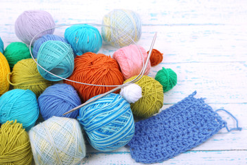 Yarns for knitting on wooden table close-up