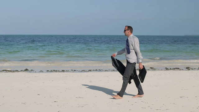 Businessman With Briefcase Walking On Exotic Beach