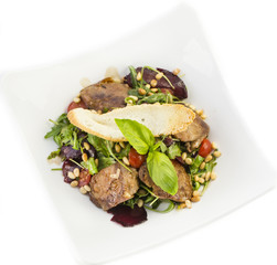 rabbit liver salad with arugula in a restaurant