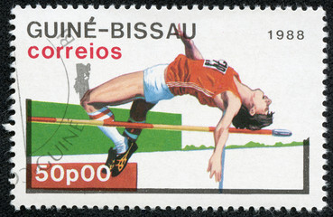 stamp printed in Guinea-Bissau showing high jump