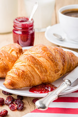 Croissants with raspberry jam and coffee.