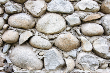 Detail of round stones and cement wall