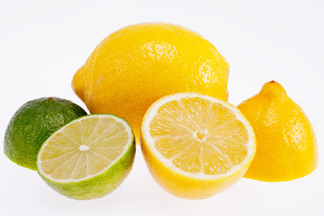 cut yellow lemons and green  limes isolated on white background