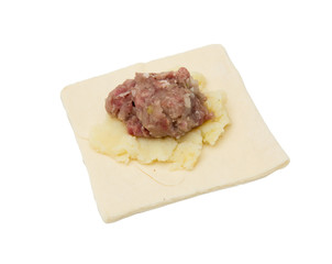 dough with meat on a white background