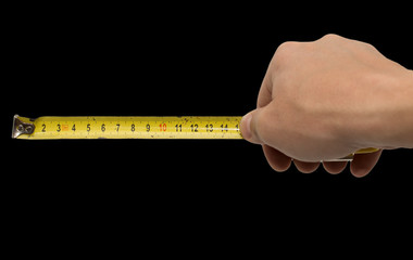 Hand with measuring tool - completely isolated on  black