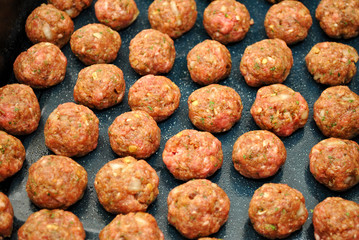 Lots of Raw Meatballs in a Pan