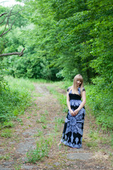 Young beautiful girl on a walk in the country