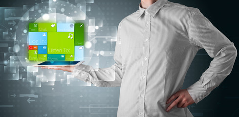 Businessman holding a tablet with modern software operational sy