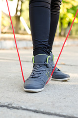 Feet of a woman athlete with a torsion rope