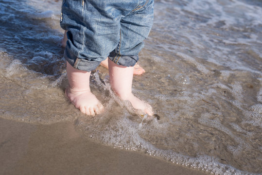 Baby Feet In Water At Beach