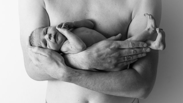 Father holding a newborn baby