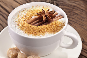 Cup of cappuccino decorated with spices.