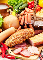 Variety of sausages with vegetables and milk products.
