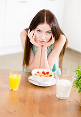Obraz na płótnie Canvas Portrait of the girl eating dieting muesli with milk 