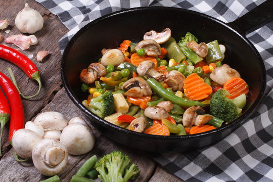 fried mushrooms with vegetables in a frying pan