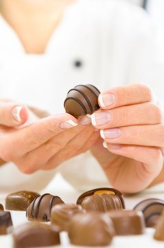 Women chef holding a Chocolate Candy