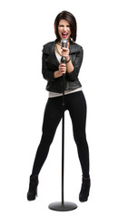 Full-length portrait of rock singer keeping static mic, isolated