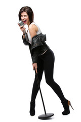 Full-length portrait of rock singer handing static mic, isolated