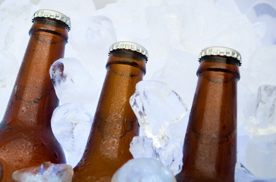 cold beer on crushed ice cubes outside