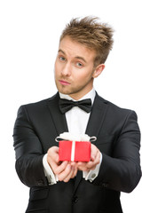 Half-length portrait of businessman keeping present box