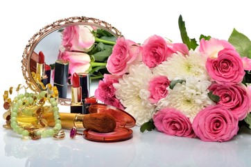 jewelry, cosmetics and a bouquet of flowers in still life