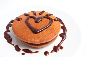 Chocolate pancakes with chocolate sauce.