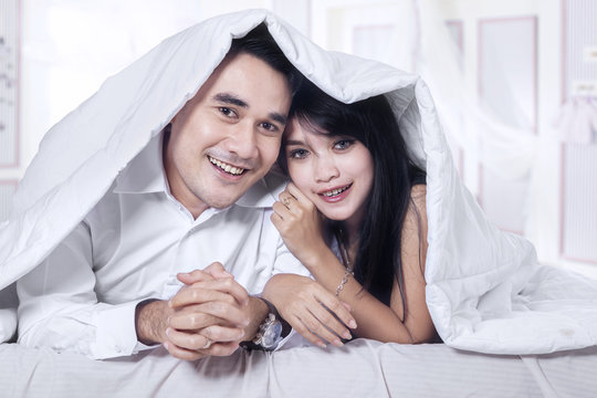 Attractive couple under blanket 1