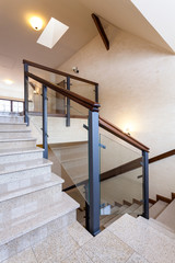 Staircase with stone steps and glass banister