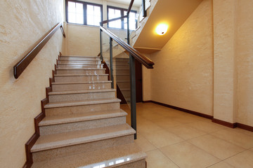 Modern stone stairs with wooden banister