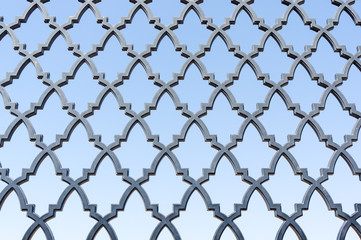 Fototapeta premium pattern of the fence grill against blue sky