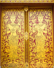 Fototapeta na wymiar Thai ancient art Gold angel painting on door in temple