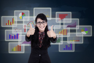 Satisfied businesswoman giving thumbs up