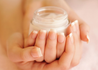 Beautiful woman hands with cream