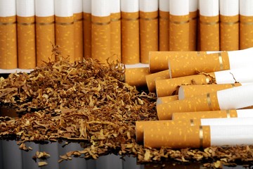 tobacco and cigarettes on the black background