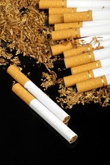 tobacco and cigarettes on the black background