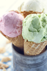 Closeup of pink and green ice cream cones