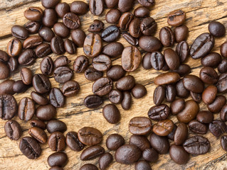 Coffee beans  on wood background .