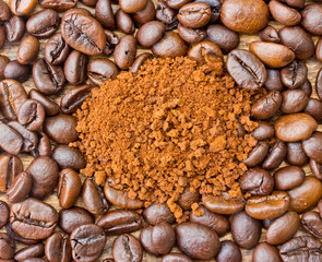 Coffee beans and coffee grind beans on wood background .