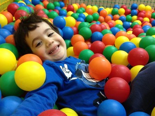 Fototapeta na wymiar boy in colorful balls playground