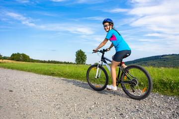 Fototapeta na wymiar Healthy lifestyle - teenage girl biking