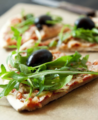 Slice of Pizza Margherita Closeup with Arugula and Olives